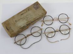 Three pairs of vintage faux tortoiseshell and yellow metal spectacles in original cardboard
