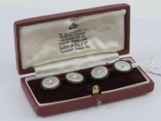 A pair of 9ct gold mother of pearl and seed pearl cuff links presented within Garrard & Co Ltd box,