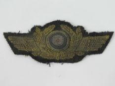 A rare WWII German Luftwaffe General gilt thread embroidered cloth cap cockade.