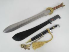 A reproduction WWII German dress dagger with scabbard, hangar and knot.