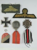A German WWII Russian Winter Campaign medal, a German Afrika Korp helmet badge,