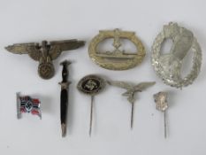 A quantity of assorted reproduction WWII German badges and pin badges. Eight items.