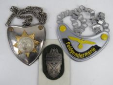 A Feldgendarmerie Gorget, an SA flag bearers gorget and a German WWII Demjansk Campaign Shield.