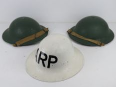 A WWII British Tommy helmet repainted, with liner and chinstrap.