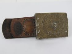 A WWII German Wehrmacht belt buckle and leather tab dated 1937.