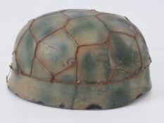 A reproduction WWII German Fallshirmjager (paratrooper) helmet with 'chicken wire' and leather