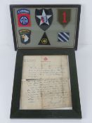 A framed montage of WWII US cloth patches.