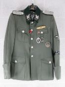 A repro Totenkopf tunic with awards (size S).