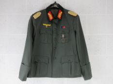 A reproduction WWII German Tunic badged to Field Marshall. Size 48.