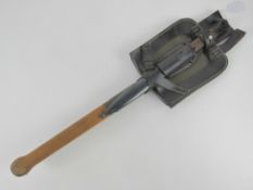 A trenching tool in leather sheath, together with a reproduction K98 bayonet with scabbard and frog.