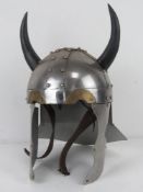 A reenactor or display medieval helmet having 'horns' upon.