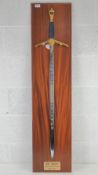 A commemorative D-Day 50th Anniversary decorative sword produced by Wilkinson Sword on wooden