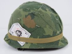 A US Vietnam war M1 helmet, Parish Division of the Dana Corporation Shell,