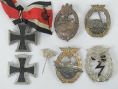 A quantity of reproduction WWII German medals and badges inc Iron cross. Seven items.