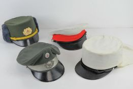 A Royal Marine dress cap (no badge, size 55), a French Foreign Legion Kepi (size 58 ½),