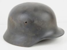 A WWII German M40 Luftwaffe helmet with liner and chin strap.