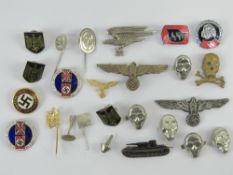 A small wooden box containing reproduction German WWII badges and insignia (25 pieces).