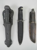 Three daggers with sheaths inc one made by Tramontina Brazil.