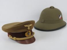 Two WWII German reproduction hats being a Pith helmet made in Vietnam,
