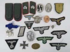 A quantity of assorted reproduction WWII German cloth patches, epaulettes, collar patches, etc.