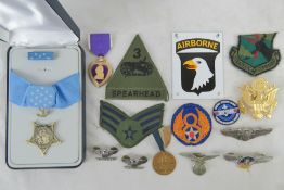 A quantity of assorted WWII USA insignia and medals including Medal of Honour and Purple heart.