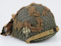 A US helmet with helmet net and scrim.