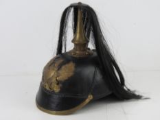 A reenactor WWI German/Prussian NCO's Pickelhaube helmet with liner.