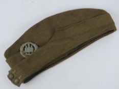 A WWII British Army forage cap with Northamptonshire cap badge dated 1943