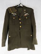 A US WWII tunic with insignia and side cap.