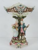 A large Capodimonte style centrepiece pedestal fruit bowl having two figures upon,