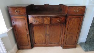 A good Georgian mahogany buffet sideboard having barrel front,