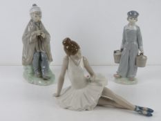 A Lladro figurine of a boy carrying twin milk pails,