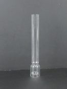 An 'as new' glass oil lamp chimney, in protective tube.