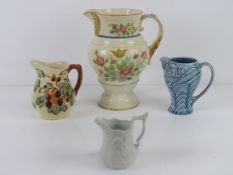 Four assorted decorative jugs inc Portmeirion Parian, Wade,