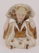 An early 20thC nid-nod figurine of a woman in Oriental dress. Approx 9cm high.