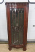A 20th century astral glazed freestanding corner cabinet in mahogany,