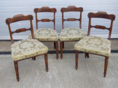A set of four late 19th century mahogany framed dining chairs having double splat and ring turned