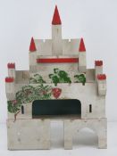 A vintage hand made castle dolls house, 28cm wide.
