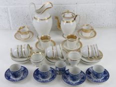 A set of four Noritake blue and white phoenix design coffee cans and saucers,