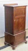 An Edwardian gramophone and music cabinet having twin slide shelves with fall front compartment
