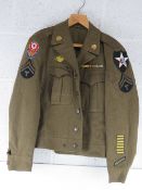 A WWII US Ike Jacket with insignia, size 36R.