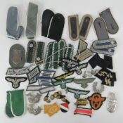 A quantity of assorted reproduction German/SS insignia, buttons and badges.