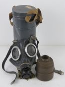 A French WWII ANP 39 gas mask in tin dated 1938.