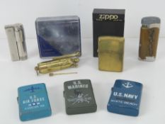 A 'US Marines' Zippo style lighter, a brass Zippo lighter in presentation box,
