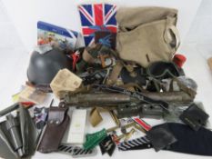 A quantity of assorted military themed and reproduction militaria; Helmet, Goggles, flags, posters,