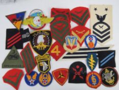 A quantity of assorted USA cloth badges and cloth rank badges (26 items).