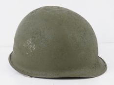 A US M1 helmet, Vietnam era.