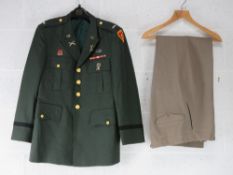 A US Dress Tunic badged to 25th Infantry Division together with a pair of US dress trousers.