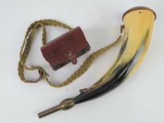 A powder horn and leather ammo pouch.