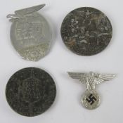 Four reproduction WWII German badges.